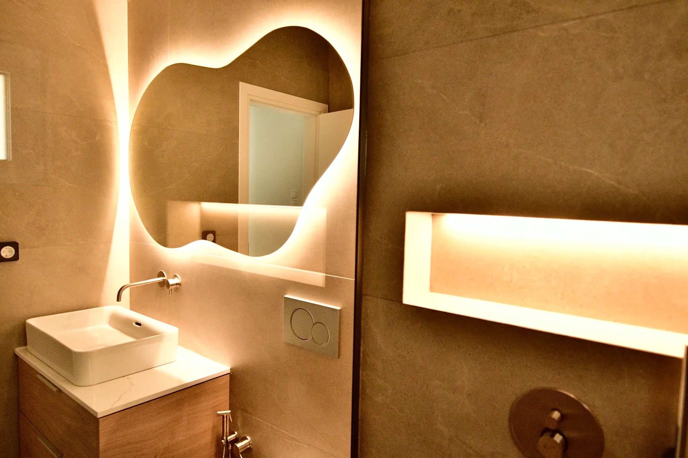 Warm perimeter lighting frames the basin zone.