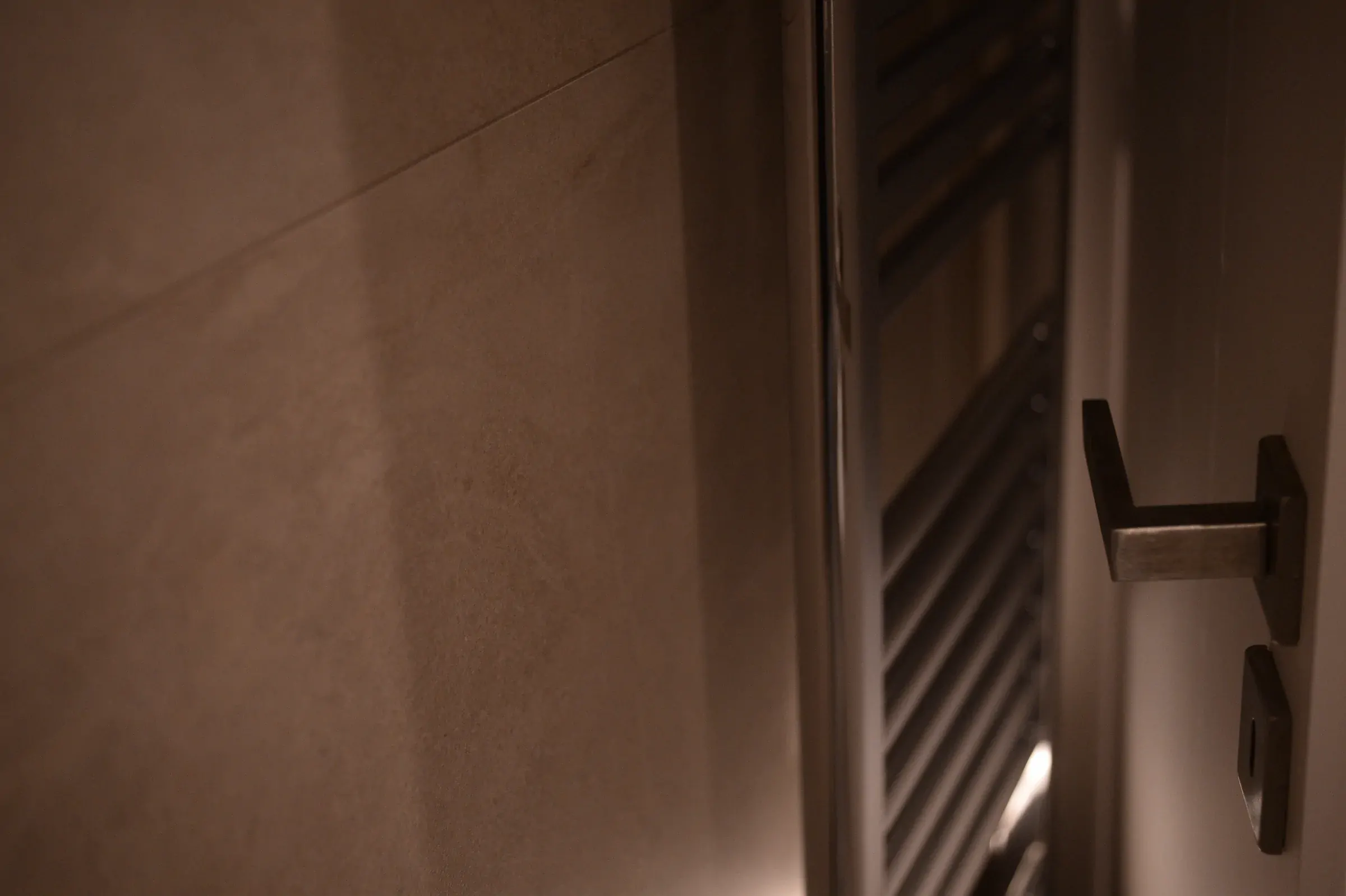 The fittings are integrated into the tiled surface with clean junctions.