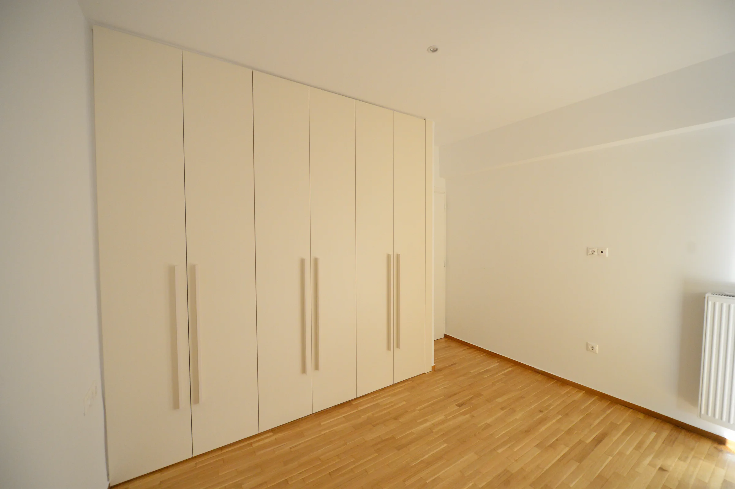 The fitted joinery makes full use of the bedroom wall.