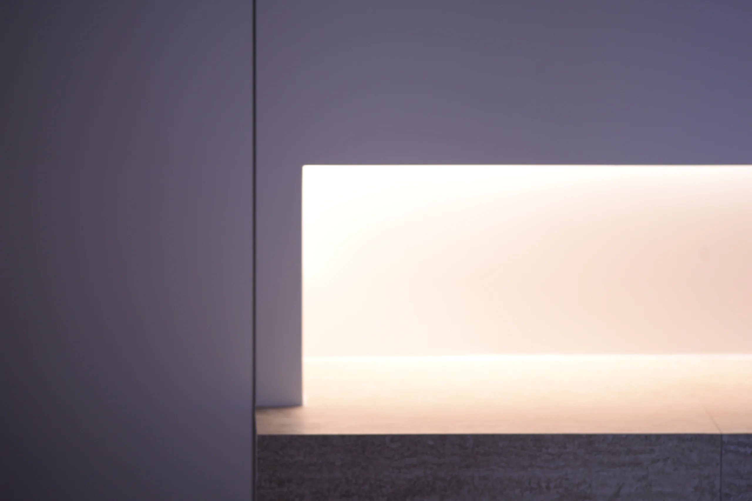 Warm low-level lighting visually lightens the built-in volume.