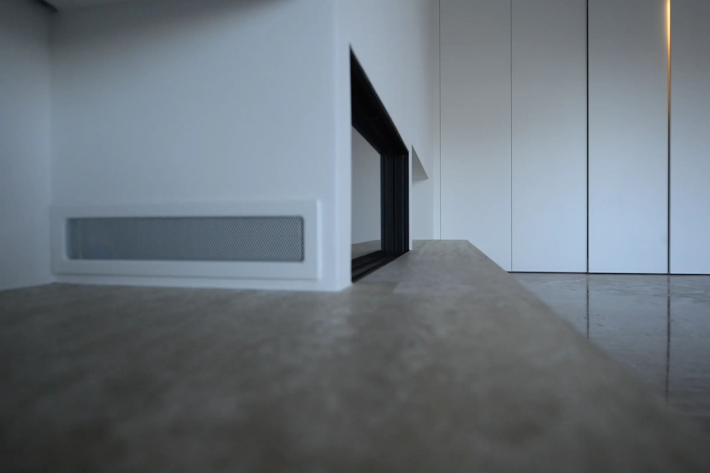 The black fireplace frame creates a disciplined contrast within the white composition.