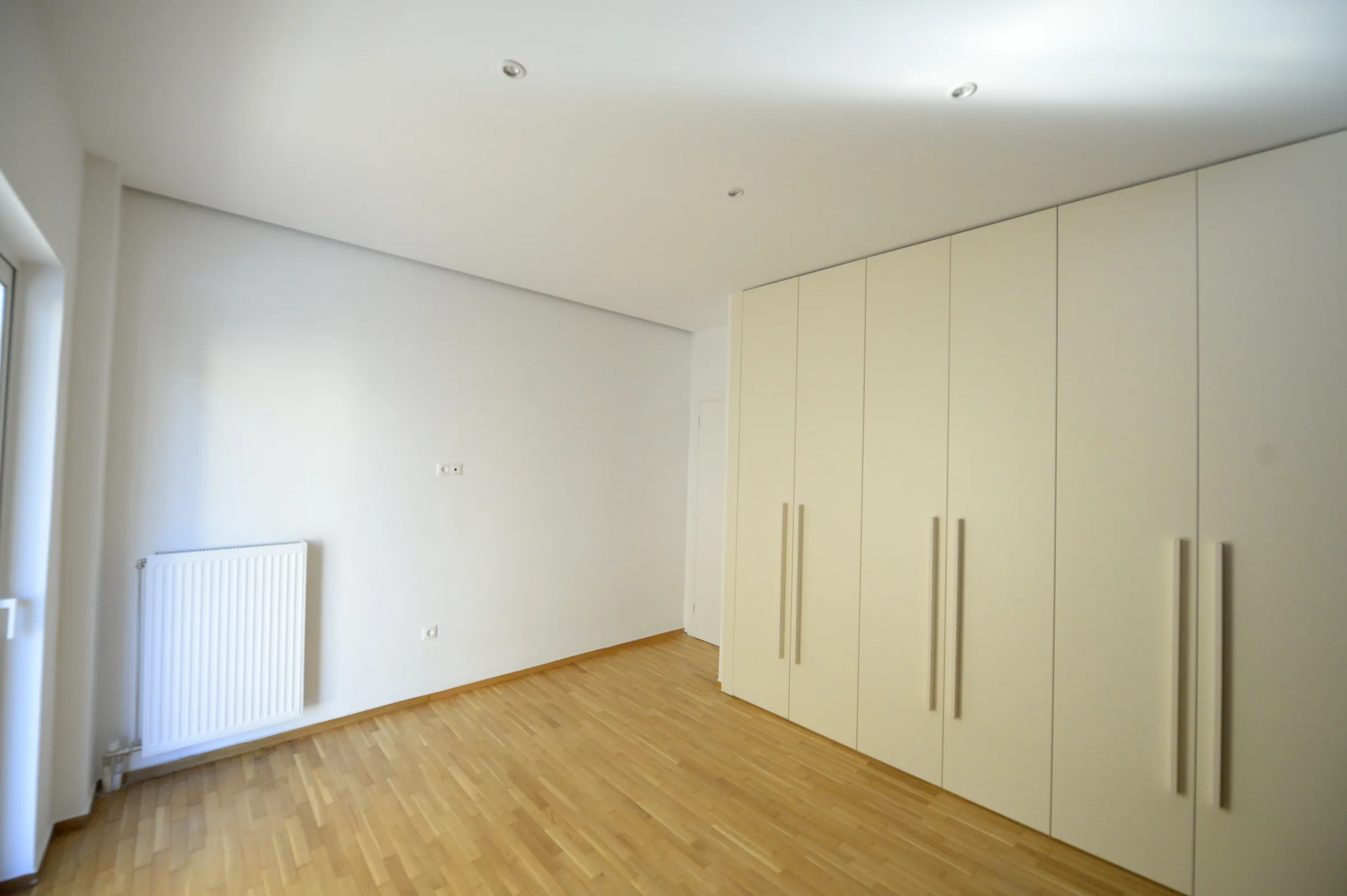 The full-height wardrobe provides generous concealed storage.