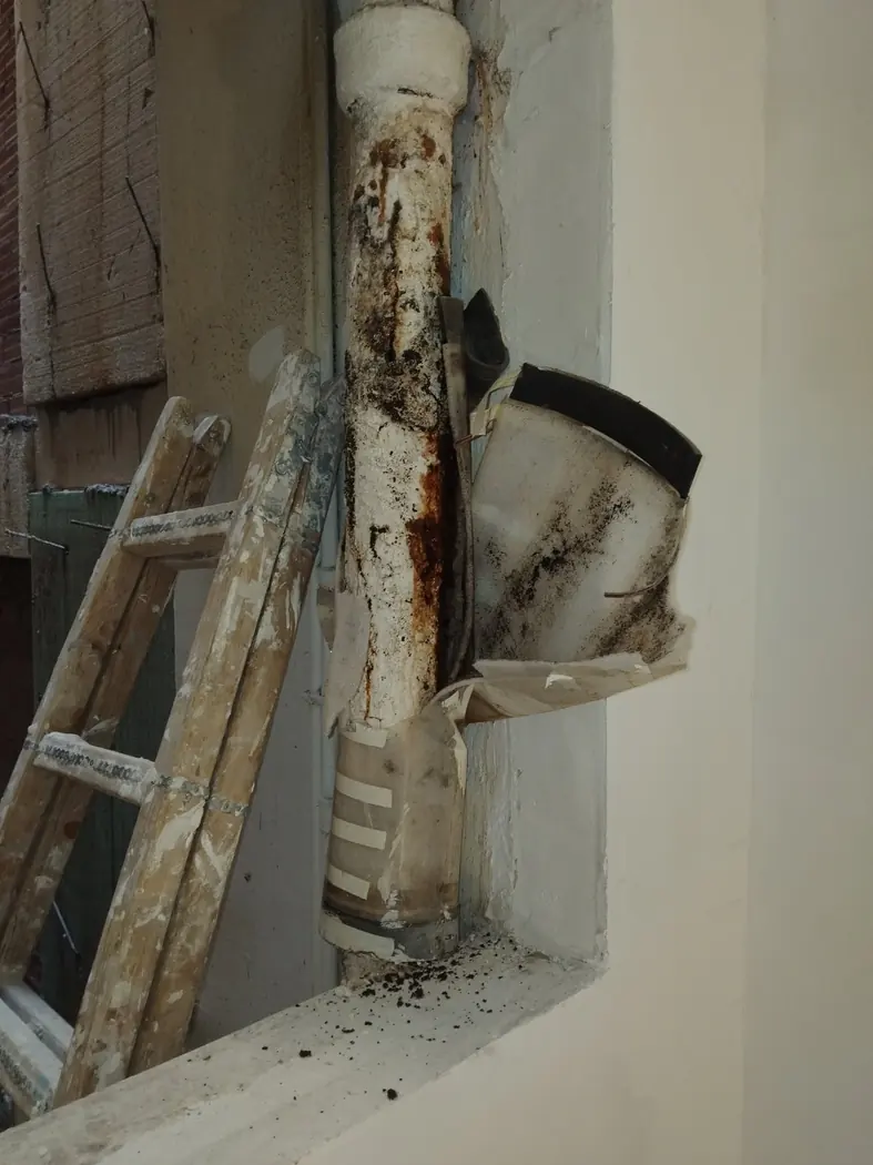 Corroded cast-iron communal drainage stack during a Renovator house renovation in Piraeus
