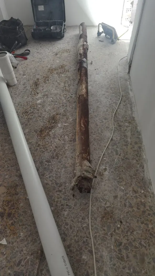 Failed cast-iron drainage pipe removed during a house renovation in Piraeus