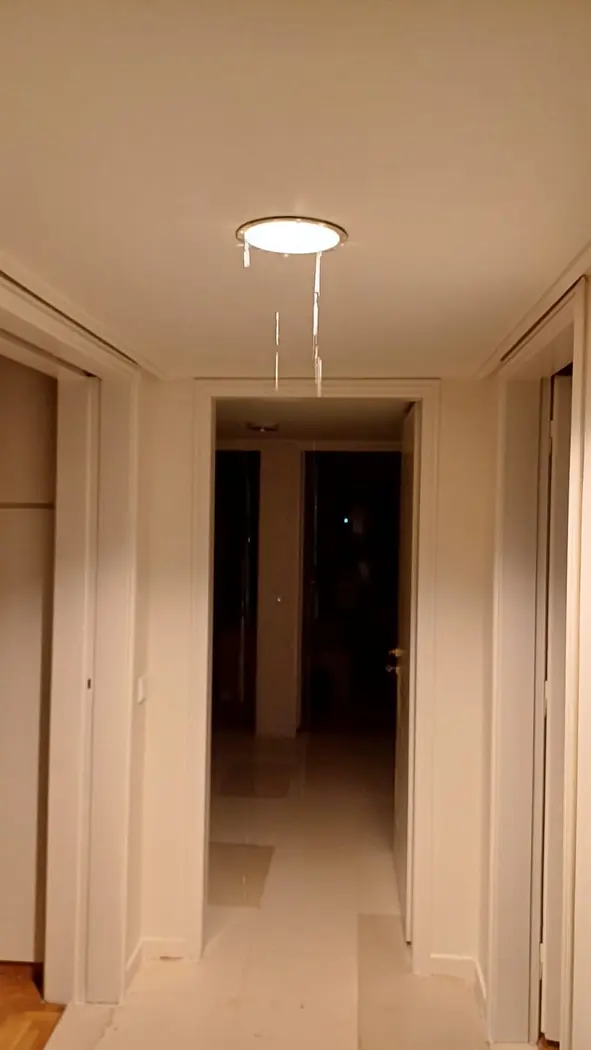 Water leaking through a ceiling light below an electric water heater